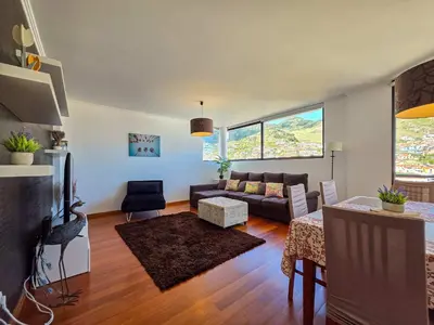 a living room with a couch and a table at Ocean View Machico in Machico