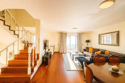 a living room with a couch and a table at Armando House Ocean View in Gaula