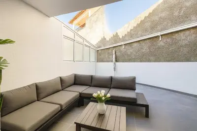 a living room with a couch and a vase of flowers at Armando House Ocean View in Gaula