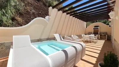 a living room with a blue couch and a view of the ocean at Villa Sol Palheiro Village by Holiday Rental Madeira in Funchal