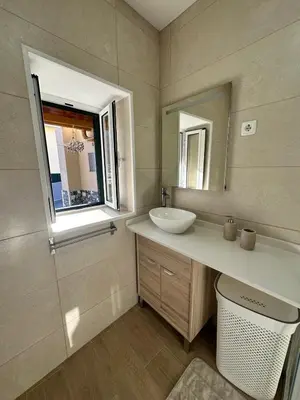 a bathroom with a sink and a mirror at Mocha Studio in Machico