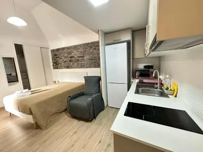 a bedroom with a bed and a kitchen with a sink at Mocha Studio in Machico