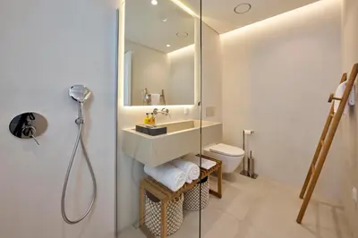 a white bedroom with a bed and a mirror at Imperatriz Villa Tropical Garden in Funchal