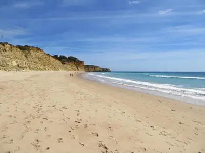 a beach with footprints in the sand and the ocean at Sea View Apartment in Lagos