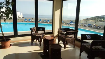 a hotel lobby with chairs and a swimming pool at Sea View Apartment in Lagos