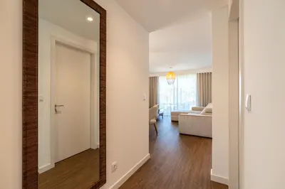 a large mirror in a living room with a bedroom at Star Lit Jacuzzi Apartment in Câmara de Lobos