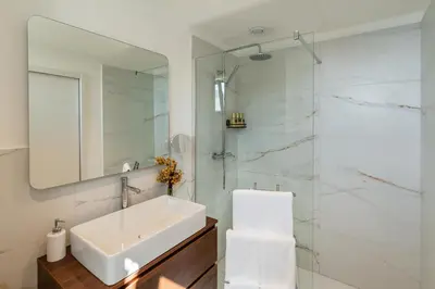 a bathroom with a sink and a mirror at Star Lit Jacuzzi Apartment in Câmara de Lobos