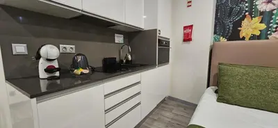 a small kitchen with a counter top with a appliance at Apartamento moderno no centro do Funchal - Banana By Tropical Solutions in Funchal