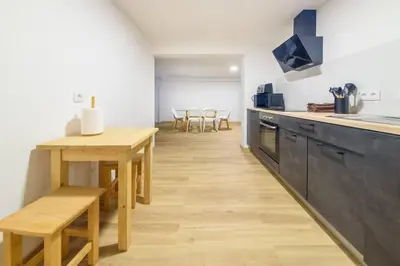 a kitchen with a wooden table and a dining room at Montana by Mth in Funchal