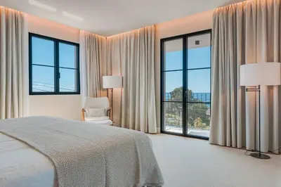 a bedroom with a bed and large windows at Villa Mangoni - Brand New Luxury Villa in Funchal