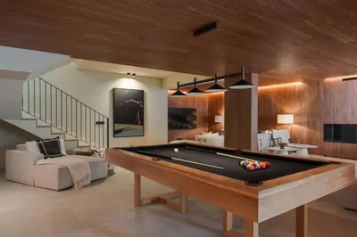a living room with a pool table and a staircase at Villa Mangoni - Brand New Luxury Villa in Funchal