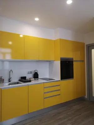 a kitchen with yellow cabinets and a sink at Apartamento moderno no Funchal - Araçá Apartment by Tropical Solutions in Funchal