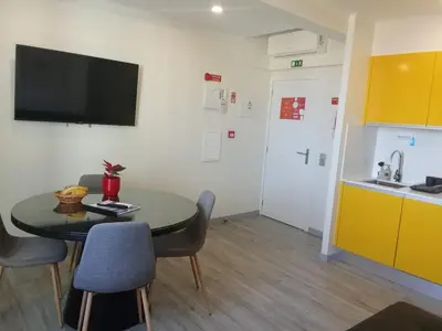 a room with a table and chairs and a kitchen at Apartamento moderno no Funchal - Araçá Apartment by Tropical Solutions in Funchal