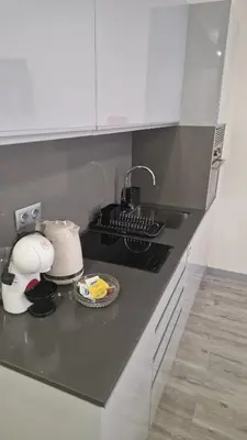 a kitchen counter top with a sink and a stove at Apartamento moderno no Funchal - Maracujá Apartment by Tropical Solutions in Funchal