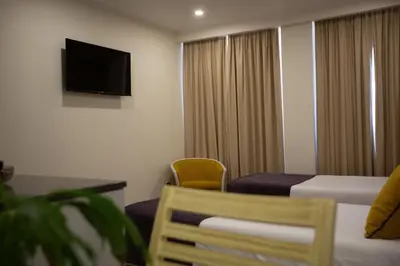 a hotel room with a bed and a flat screen tv at Apartamento moderno no Funchal - Maracujá Apartment by Tropical Solutions in Funchal