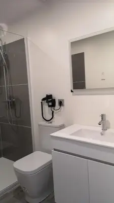 a bathroom with a toilet and a sink and a shower at Apartamento moderno no centro do Funchal - Tabaibo By Tropical Solutions in Funchal