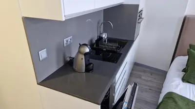 a kitchen counter with a sink in a room at Apartamento moderno no centro do Funchal - Tabaibo By Tropical Solutions in Funchal