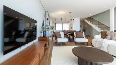 a living room with a couch and a table at Villa Nero by LovelyStay in Funchal