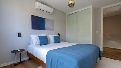 a bedroom with a large bed with blue sheets at Villa Nero by LovelyStay in Funchal