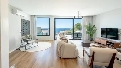 a living room with a view of the ocean at Villa Nero by LovelyStay in Funchal