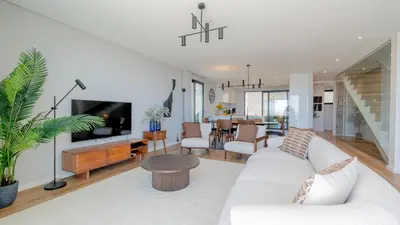 a living room with a white couch and a tv at Villa Nero by LovelyStay in Funchal