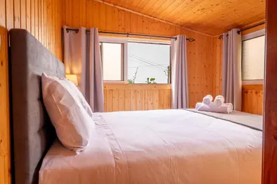 a bedroom with a bed with two stuffed animals on it at Casa Do Senhor, By OP in São Vicente
