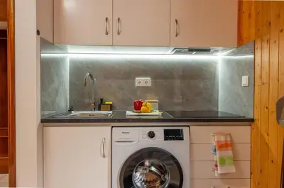 a kitchen with a washing machine and a sink at Casa Do Senhor, By OP in São Vicente