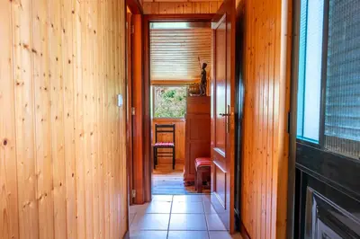 a hallway leading to a dining room with a table at Casa Do Senhor, By OP in São Vicente