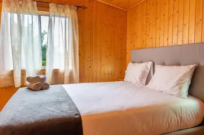 a bedroom with a large bed with a window at Casa Do Senhor, By OP in São Vicente