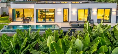 a house with a swimming pool in front of it at Eco Fajã Villas in Arco da Calheta