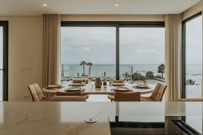 a dining room with a table and a view of the ocean at Eco Fajã Villas in Arco da Calheta