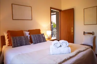 a room with a tv and a bed with towels at Casa Lucas by Escape to Madeira in Arco da Calheta