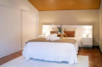 a bedroom with a white bed with towels on it at Casa Lucas by Escape to Madeira in Arco da Calheta