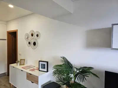 a white room with a desk and a plant at São Cristóvão AL in Boaventura