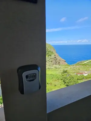 a door knob with a view of the ocean at São Cristóvão AL in Boaventura