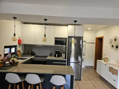 a kitchen with white cabinets and a counter top at São Cristóvão AL in Boaventura