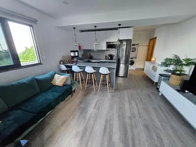 a living room with a couch and a kitchen at São Cristóvão AL in Boaventura