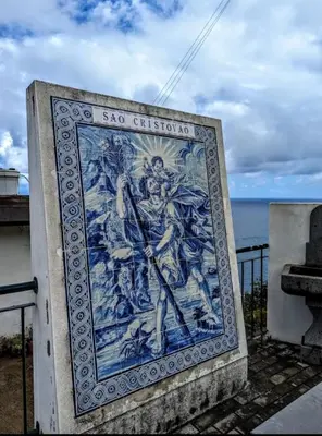 a mural on the side of a building with the ocean in the background at São Cristóvão AL in Boaventura