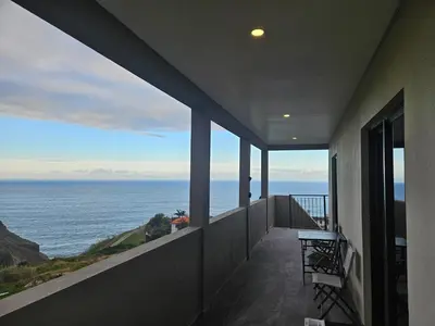 a balcony with a view of the ocean at São Cristóvão AL in Boaventura