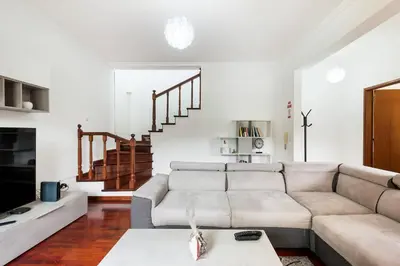 a living room with a couch and a staircase at Sol Poente by GALMI in Funchal