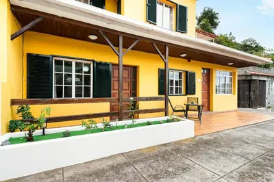 a yellow house with black shutters at Sol Poente by GALMI in Funchal