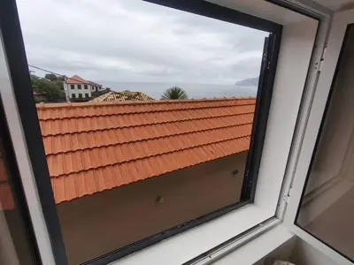 a bedroom with a bed in a white room at Alojamiento Local - Estrela do Norte in Seixal