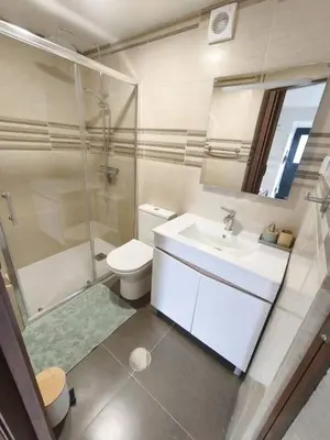 a bathroom with a sink and a toilet and a mirror at Alojamiento Local - Estrela in Seixal