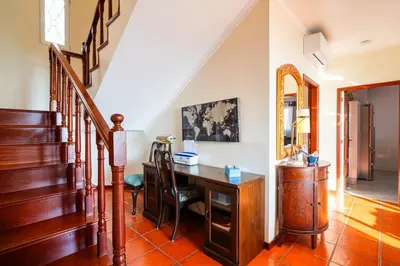 a home office with a desk and stairs at GuestReady - Sea-View Retreat in Madeira in Funchal