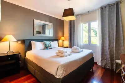a bedroom with a bed with towels on it at GuestReady - Sea-View Retreat in Madeira in Funchal