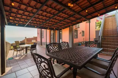 a patio with a table and chairs on a balcony at GuestReady - Sea-View Retreat in Madeira in Funchal