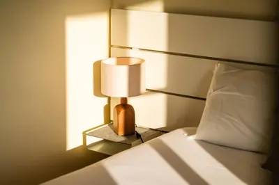 a bedroom with a bed and a lamp on a night stand at GuestReady - Sea-View Retreat in Madeira in Funchal