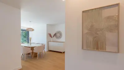 a dining room with a table and a picture on the wall at Acqua Sensation Suites by LovelyStay in Funchal