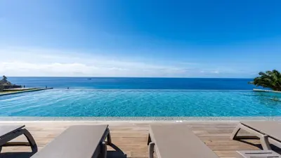 a swimming pool with a view of the ocean at Acqua Sensation Suites by LovelyStay in Funchal