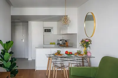 a kitchen with a table and chairs and a mirror at Madeira Aqua Dream in Funchal
